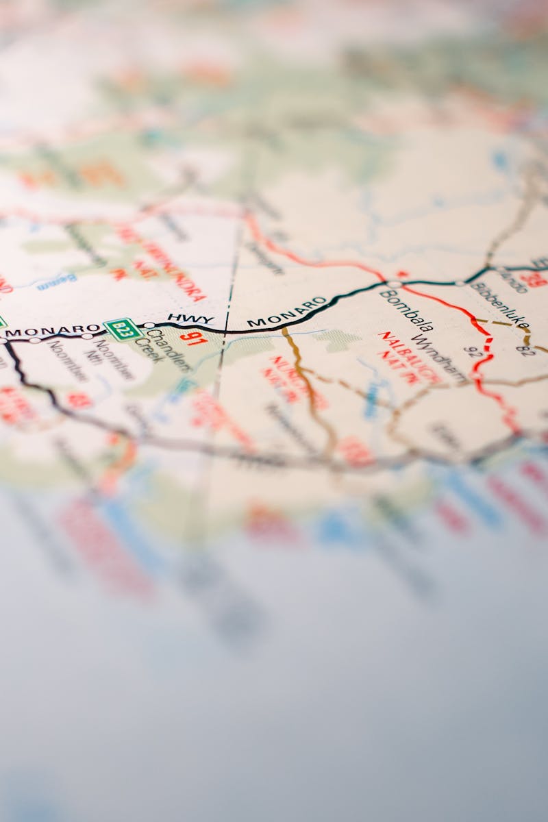 Focus on intricate details of a geographic map, highlighting travel routes.